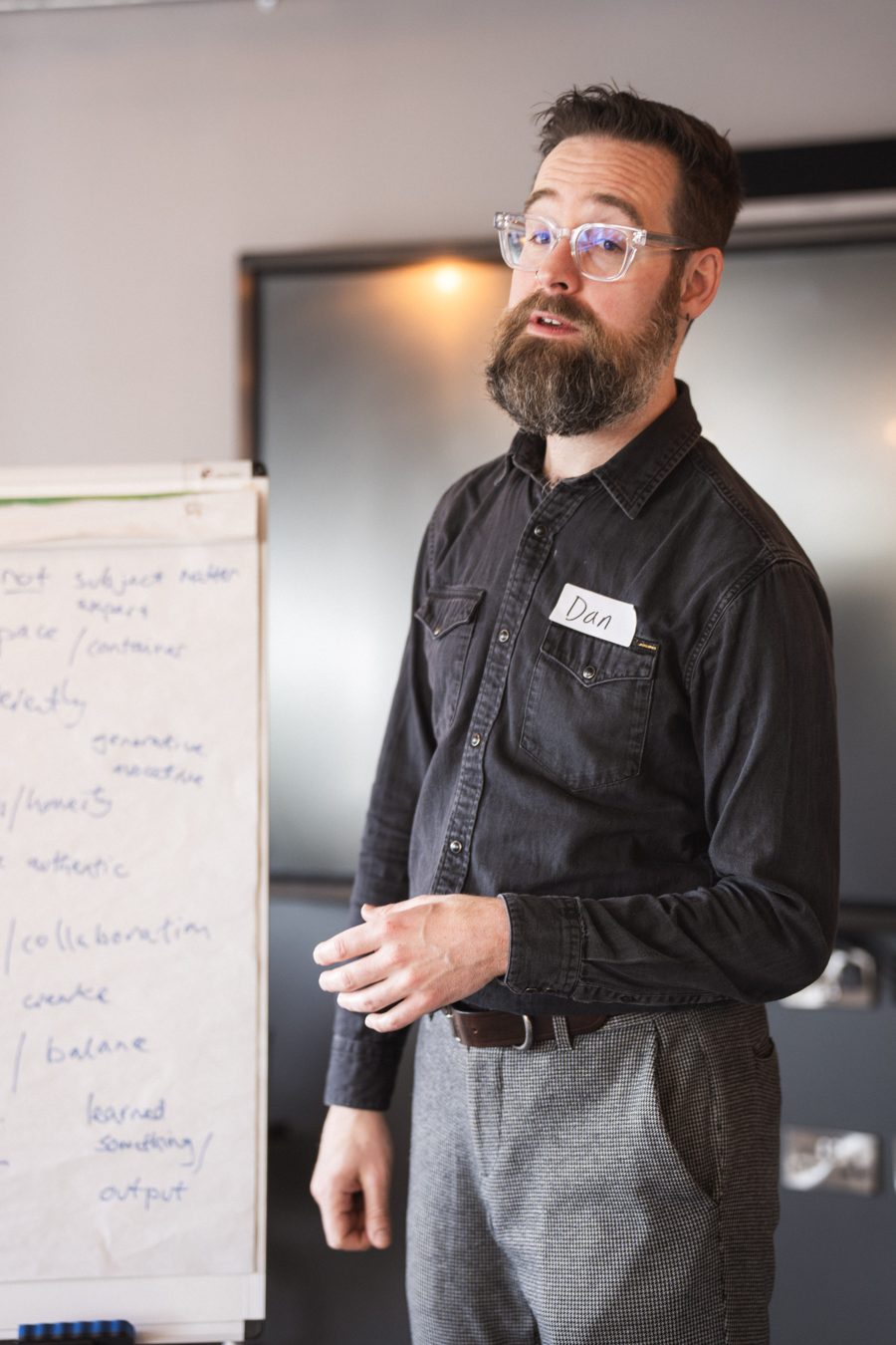 Dan Simpson facilitating a workshop, standing beside a flipchart